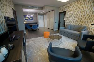 a living room with a couch and a table at Doubletree By Hilton Pointe-Noire City Centre in Pointe-Noire
