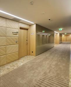 a large hallway with wooden cabinets and a hallway with a corridorngthngthngthngth at DoubleTree by Hilton Istanbul-Avcilar in Istanbul