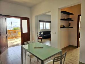 a dining room and living room with a table and chairs at Casa Cernicalo in Nazaret