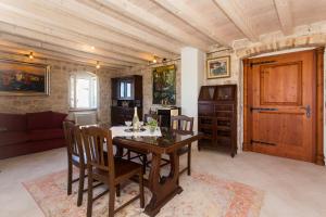 a dining room with a wooden table and chairs at Heritage Art Home in Trogir