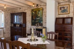 a dining room with a table and chairs at Heritage Art Home in Trogir