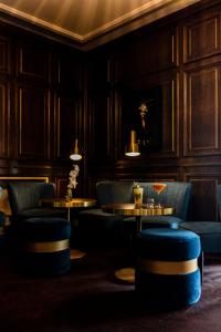 un restaurant avec deux tables et des chaises bleues dans l'établissement Hôtel le Touring, à Saint-Raphaël