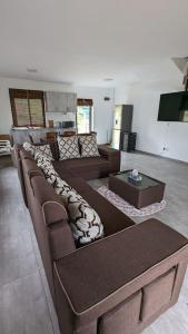 a living room with two couches and a table at Haven Green Village in Grand Gaube