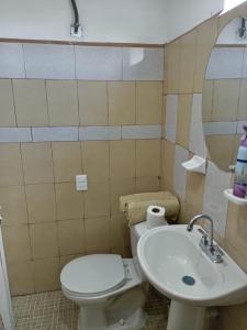 a bathroom with a toilet and a sink at Casa Itanuni in Santa Lucía
