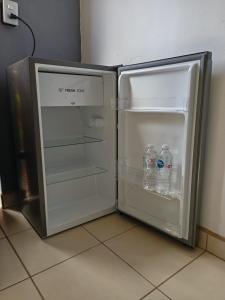 an open refrigerator with two bottles of water in it at Casa Itanuni in Santa Lucía