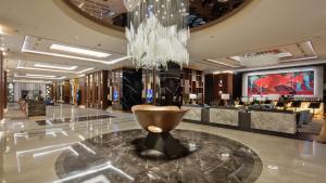 a lobby with a chandelier and a large bowl on the floor at Hilton Istanbul Maslak in Istanbul