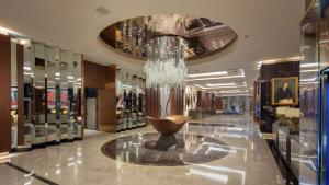 a lobby with a chandelier in the middle of a store at Hilton Istanbul Maslak in Istanbul