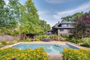 a swimming pool in the yard of a house at Upscale Arts and Crafts Bungalow with Yard, Pool! 