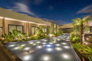a villa with a garden at night at DoubleTree By Hilton Izmir Airport in İzmir
