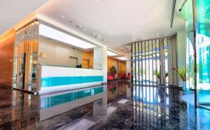 a lobby with a swimming pool in a building at DoubleTree by Hilton Ankara Incek in Ankara