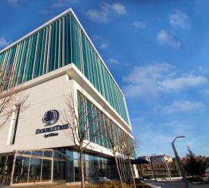 a building with a sign on the side of it at DoubleTree by Hilton Ankara Incek in Ankara