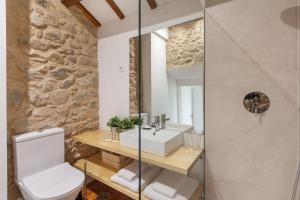 a bathroom with a white toilet and a sink at Casa Grande - Minho's Guest in Braga