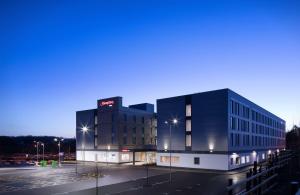 a building with a sign on the side of it at Hampton By Hilton Bristol Airport in Redhill