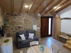 a living room with a couch and a table at O Muiño do Torneiro in A Pobra do Caramiñal