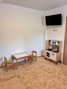 a living room with a table and a tv at U Srubu in Moravany +23 photos