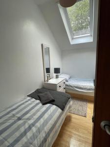 a bedroom with a bed and a mirror at 20 Strawberry Hill cosy cottage sleeps 5 in Hayle