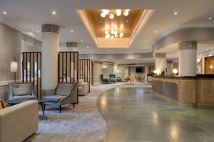 a lobby of a hotel with chairs and tables at Hilton Nottingham Hotel in Nottingham