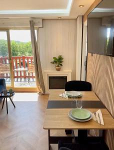 une salle à manger avec une table et un salon dans l'établissement Splendide Studio avec balcon - Trouville centre, à Trouville-sur-Mer