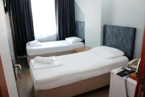 Postel nebo postele na pokoji v ubytování biglife hotel