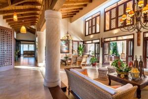 a living room filled with furniture and a chandelier at Sunny Vacation Villa No 68 in San Rafael del Yuma