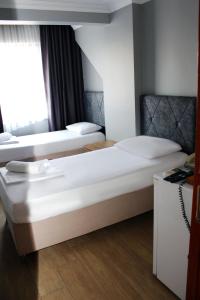 Postel nebo postele na pokoji v ubytování biglife hotel