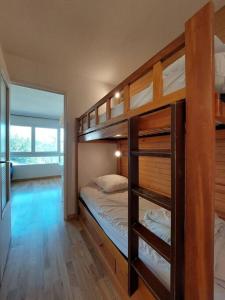 two bunk beds in a room with a room with at Joli studio 4 couchages aux pieds des pistes in Puy-Saint-Vincent