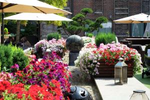 a garden filled with lots of colorful flowers at Hilton London Syon Park in Brentford