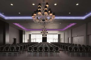 a large room with chairs and a chandelier at Hilton London Syon Park in Brentford