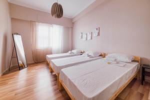 a room with two beds and a window at The Easy in Thiseio next to ancient Athens in Athens