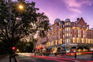 a large building on a city street at night at Hilton London Hyde Park in London