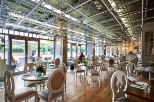 a restaurant with tables and chairs and people in the background at Hilton London Hyde Park in London