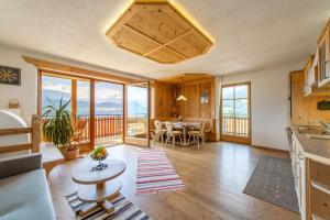 a kitchen and living room with a table and chairs at Huberhof in Villandro