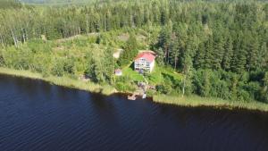 an aerial view of a house on an island in the water at Jacuzzi Rantakallio in Melkoniemi