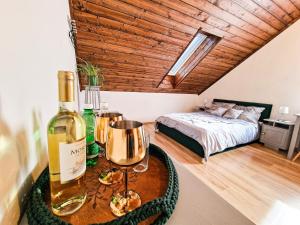 Schlafzimmer mit einer Flasche Wein und einem Bett in der Unterkunft GraVelo - Apartament Jacuzzi in Bartkowa-Posadowa