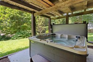 a hot tub sitting under a pergola at Banner Barn in Banner Elk