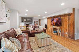 a living room with a leather couch and a table at Banner Barn in Banner Elk +36 photos