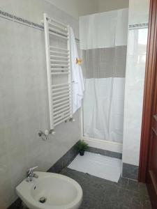 a bathroom with a sink and a shower and a toilet at Villino Ulivo in Le Casette