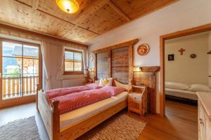 a bedroom with a bed and a cross on the wall at Huberhof in Villandro