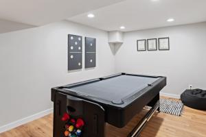 a room with a ping pong table in the middle of a room at Banner Barn in Banner Elk