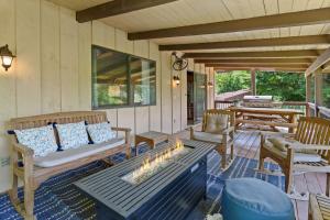 a porch with a couch and a fire pit at Banner Barn in Banner Elk