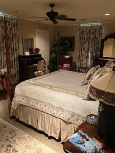 a bedroom with a large bed and a piano at The Lasker Inn in Galveston