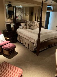 a bedroom with a large bed and a chair at The Lasker Inn in Galveston