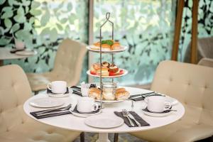 a table with a tray of pastries and coffee cups at Hilton Southampton - Utilita Bowl in Southampton