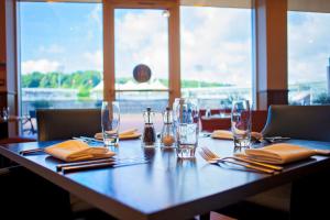 a long table with glasses and napkins on it at Hilton Southampton - Utilita Bowl in Southampton