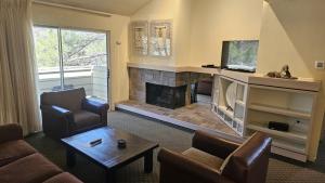 a living room with a couch and a fireplace at Club Lakeridge in Reno