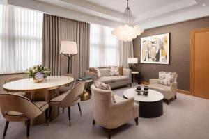 a living room with a table and chairs at Conrad London St James in London