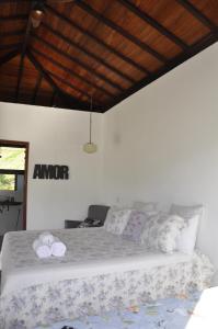 Ένα ή περισσότερα κρεβάτια σε δωμάτιο στο Casa Cambuí Hospedagem Rural