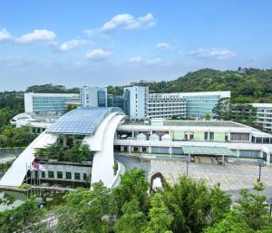 Hilton Guangzhou Science City, Free Shuttle Bus to Canton Fair في قوانغتشو: مبنى بسقف زجاجي في مدينة