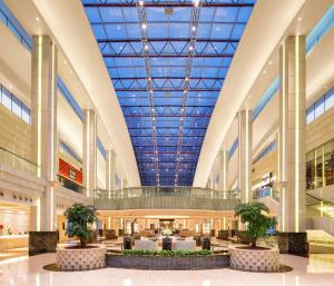 a large shopping mall with a large ceiling at Hilton Guangzhou Science City, Free Shuttle Bus to Canton Fair in Guangzhou