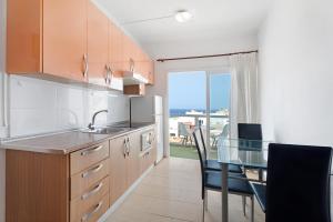 a kitchen with a table and a dining room at Alcamar in Alcalá +13 photos